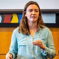 woman presenting with an OWL speaker behind her in conference room